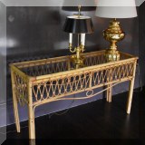 F10. Vintage rattan and glass top console table. 28”h x 52”w x 17”d 